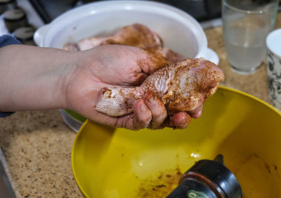 Preparing chicken legs for roasting.