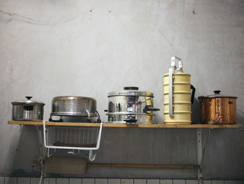 Old kitchen ware hanging on shelf. 