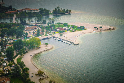 High angle view of sea by trees at hazy weather 