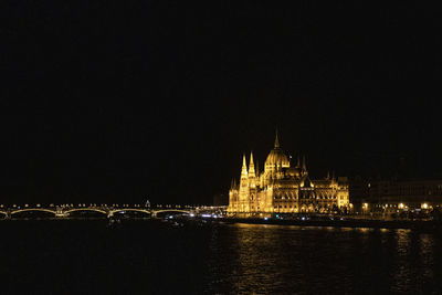 Illuminated city against sky at night