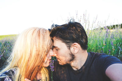 Smiling young couple on field