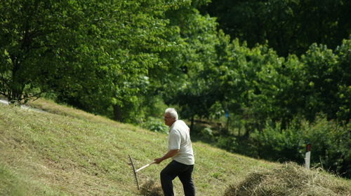 Rear view of man walking on grass