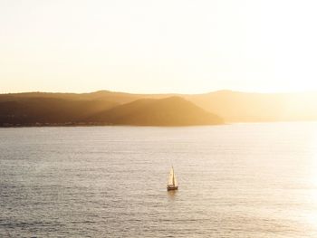 Sailboat in sea against sky