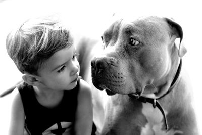 Close-up of boy looking at dog