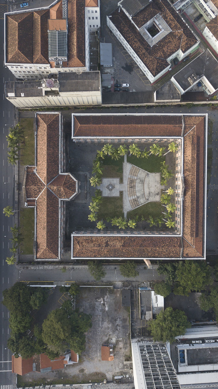 HIGH ANGLE VIEW OF TEXT ON STREET BY BUILDINGS