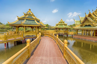 View of temple by building against sky