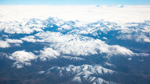 Aerial view of snowcapped mountains against sky