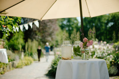 Lemonade glass bottle on table at yard at summer party