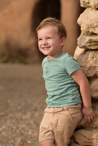 Portrait of boy standing on field