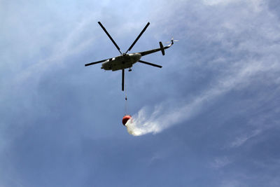 Helicopters carry water to extinguish forest and land fires.