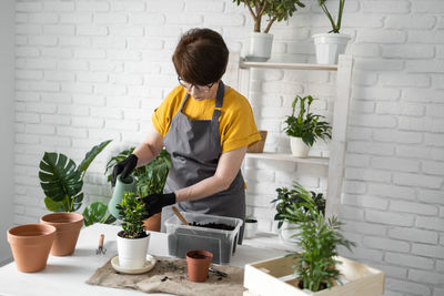 Side view of woman gardening at home