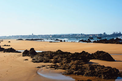 Scenic view of beach against clear sky