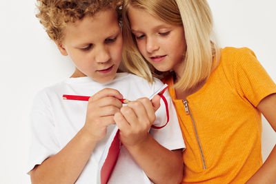 Brother writing in diary against white background