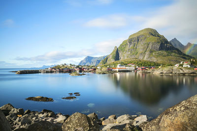 Scenic view of sea and mountains against sky