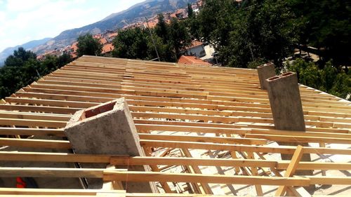 Wooden roof of building and mountains against sky