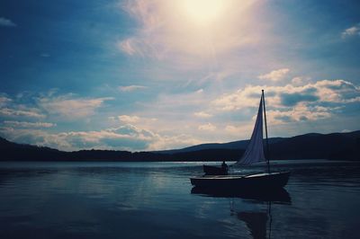 Sailboat in sea against sky
