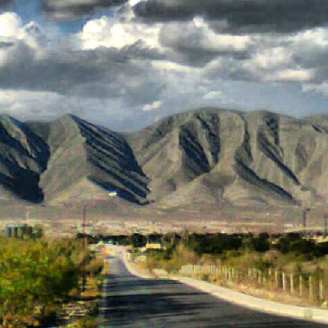 the way forward, road, tranquil scene, tranquility, scenics, sky, beauty in nature, diminishing perspective, nature, landscape, cloud - sky, mountain, vanishing point, non-urban scene, transportation, cloudy, idyllic, water, country road, remote