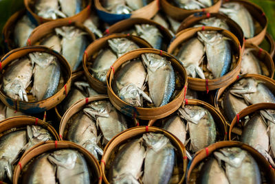 Full frame shot of fishes in baskets at market for sale