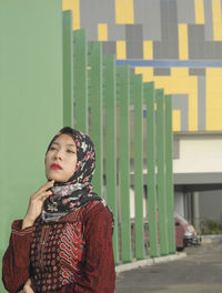 Portrait of young woman looking away outdoors