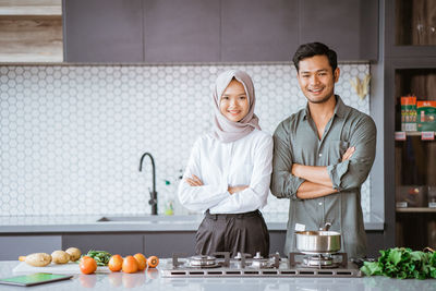 Portrait of smiling female friends standing at home