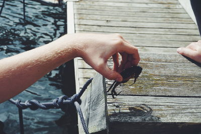 Close-up of man hand holding railing