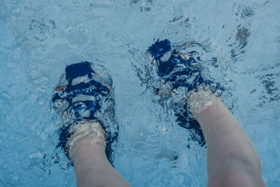 Low section of person in swimming pool