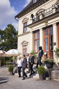 Business people leaving elegant restaurant