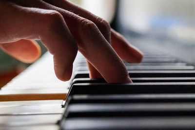 Cropped image of hands playing piano