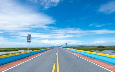 Empty road against blue sky