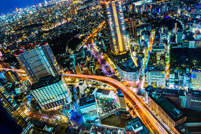 High angle view of illuminated buildings in city at night