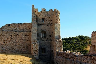 Old ruin building against blue sky