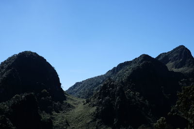 Scenic view of mountains against clear blue sky