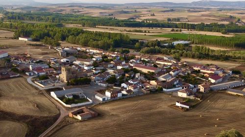 High angle view of buildings and agricultural field
