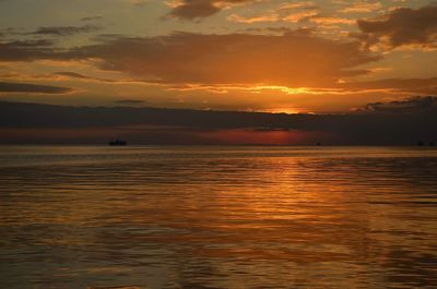 Scenic view of sea against orange sky