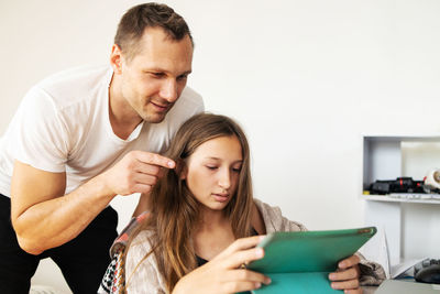 Side view of young man working at home