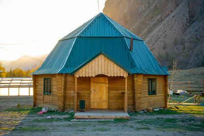 House on field against clear sky