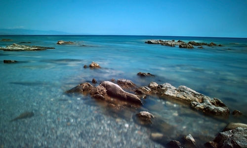 Scenic view of sea against clear blue sky