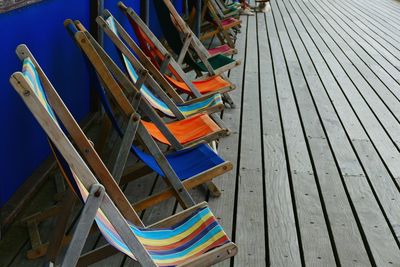 Empty deck chairs on pier