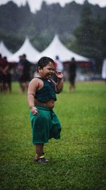 Rear view of father and son on field