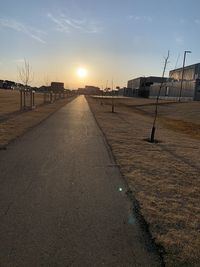 Street against sky during sunset