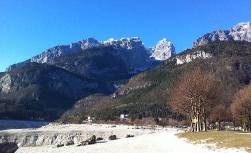 Scenic view of snowcapped mountains against clear blue sky