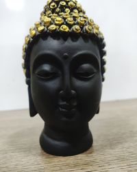 Close-up of buddha statue on table