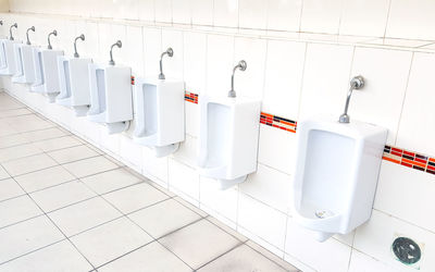 View of urinal in public restroom