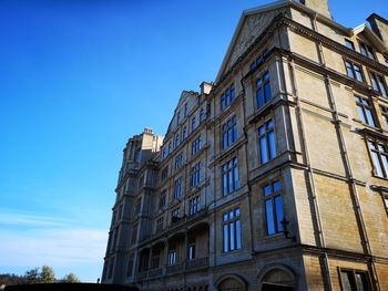 Low angle view of building against clear blue sky