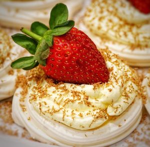 Close-up of strawberry on whipped cream