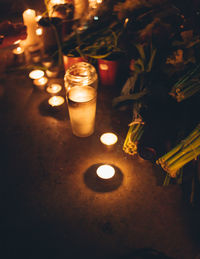 High angle view of illuminated candles on table