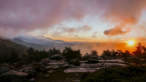 Scenic view of mountains against cloudy sky