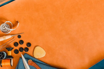 High angle view of coffee beans against orange background