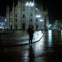 Blurred motion of woman in city at night