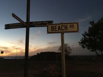 Information sign against sky